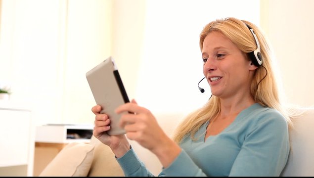 Young attractive woman blonde chatting on tablet