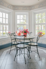 Vase of flower on table with windowsill in background