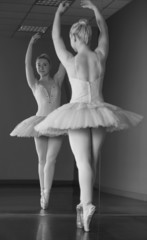 Graceful ballerina standing en pointe in front of mirror © WavebreakMediaMicro