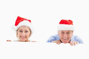 Festive mature couple smiling at camera