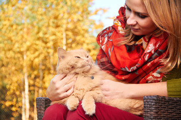 young girl with cat on natural background