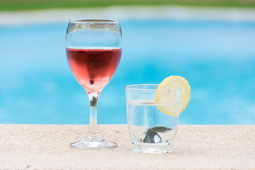 Glass of wine and water in the pool