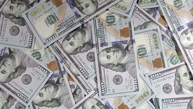 One hundred dollars pile as background.