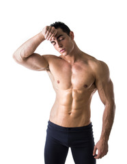 Fototapeta premium Shirtless muscular male bodybuilder wiping sweat off