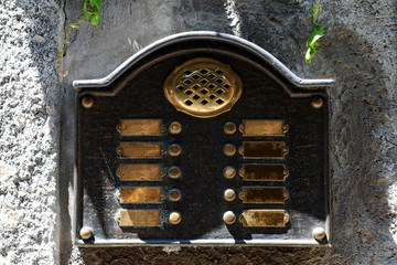Brass intercom plate at an entrance