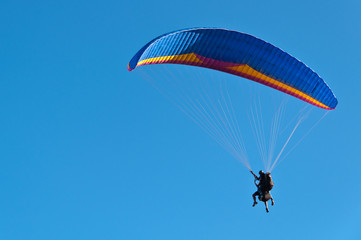Blue Paraglider in Blue Sky