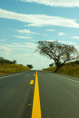 Fototapeta premium Straight road touching the sky