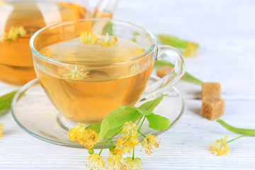 Tasty herbal tea with linden flowers on wooden table