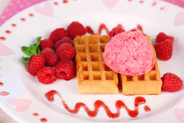 Tasty belgian waffles with ice cream on wooden table