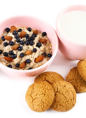 Healthy oatmeal in bowl with berries and fruits, close up