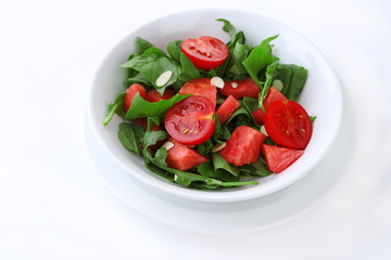 Salad with watermelon, onion, arugula and spinach leaves