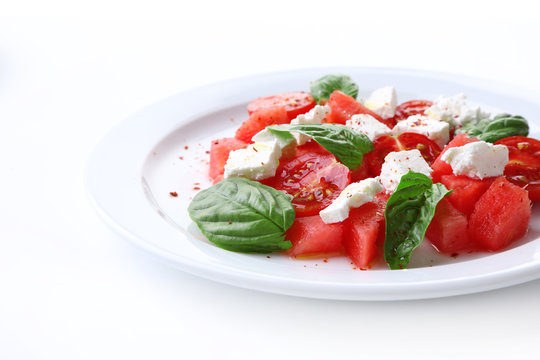 Salad with watermelon, feta and basil leaves