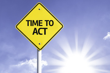 Time to Act road sign with sun background