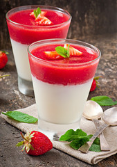 Dessert Panna Cotta with fresh strawberry on old wooden backgrou
