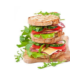 Sandwich with ham, cheese and fresh vegetables on white backgrou