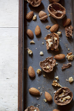 still life composition with cracked walnuts and almonds