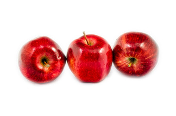 tree red apples in different put lied on