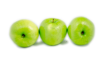 tree green apples in different put lied on