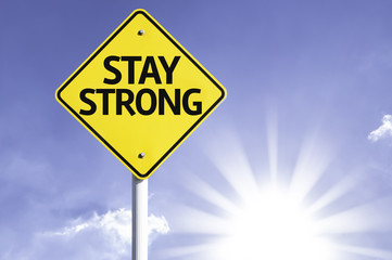 Stay Strong road sign with sun background