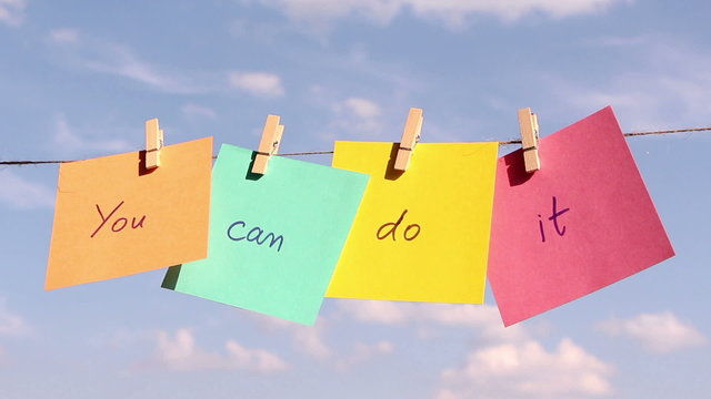 sentence "You Can Do It" on colorful paper pinched on a rope.