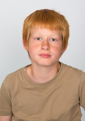 boy with red hair looking serious