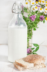 Fresh milk in old fashioned bottle and homemade bread