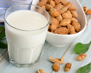 Almond milk in glass with almonds