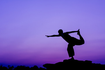 Silhouette of a man in Yoga posting