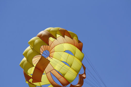 Parasailing against blue sky