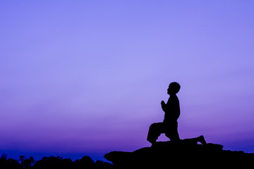 Silhouette of a man in Yoga posting