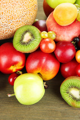 Assortment of juicy fruits, on wooden background
