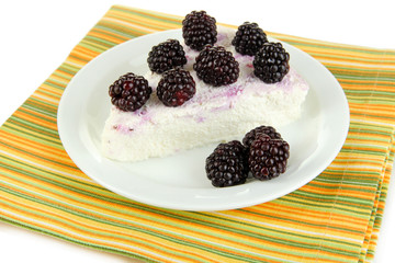 Cheesecake with fresh berries on white plate closeup