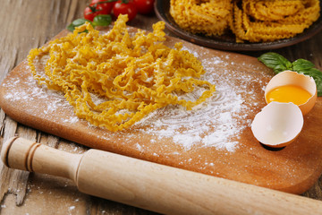 Still life with raw homemade pasta and ingredients for pasta
