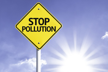 Stop Pollution road sign with sun background