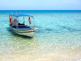 Fototapeta na wymiar Boat Floating on Turquoise Colored Water