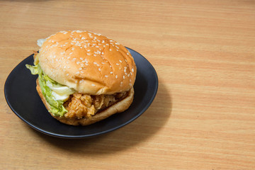 hamburger with chicken on table
