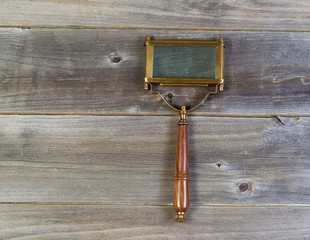 old rectangular shaped magnifying glass on rustic wood