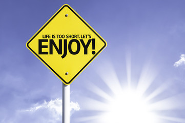 Life is Too Short. Let's Enjoy road sign with sun background