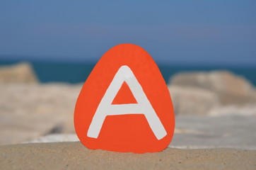 A, first letter on a colored stone
