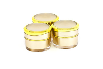 Gold cream container on white background