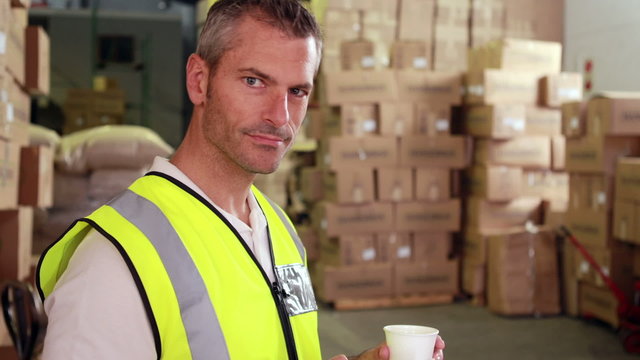 Warehouse worker sending a text on his break