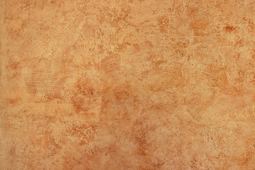 Detail of a textured orange wall