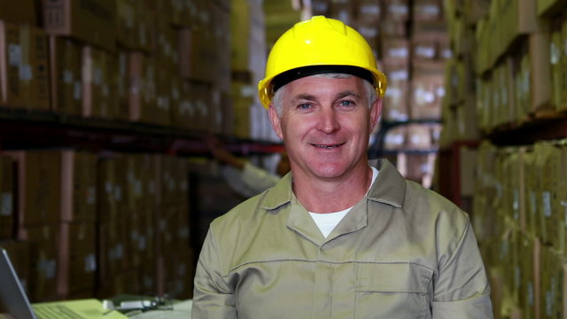 Warehouse worker smiling at camera