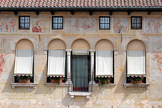 Ancient facade decorated with frescoes, Italy