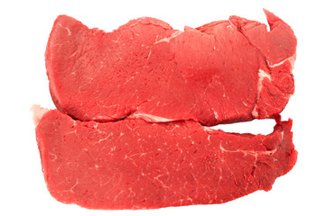 Two raw beef steaks isolated on white background