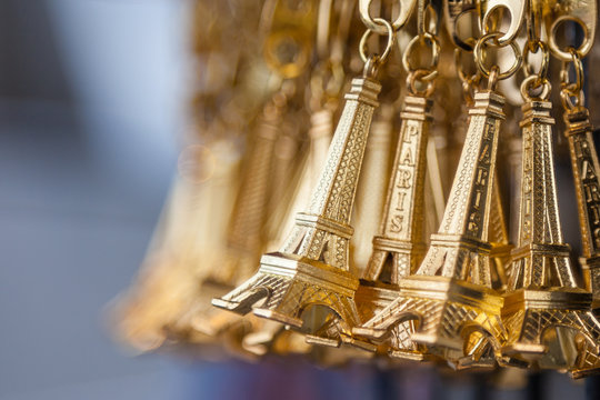 Small gold Eiffel tower key chain in a souvenir shop