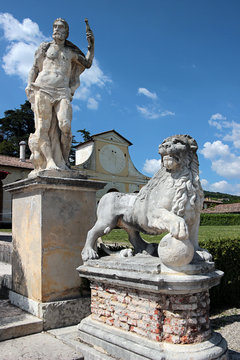 View of two statues in the garden of Villa Barbaro, Italy