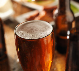 beer and chicken wings with bbq sauce in background