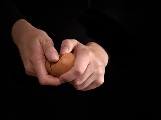 Hands breaking an egg.