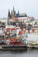 Obraz premium Snowy Prague gothic Castle above River Vltava, Czech Republic
